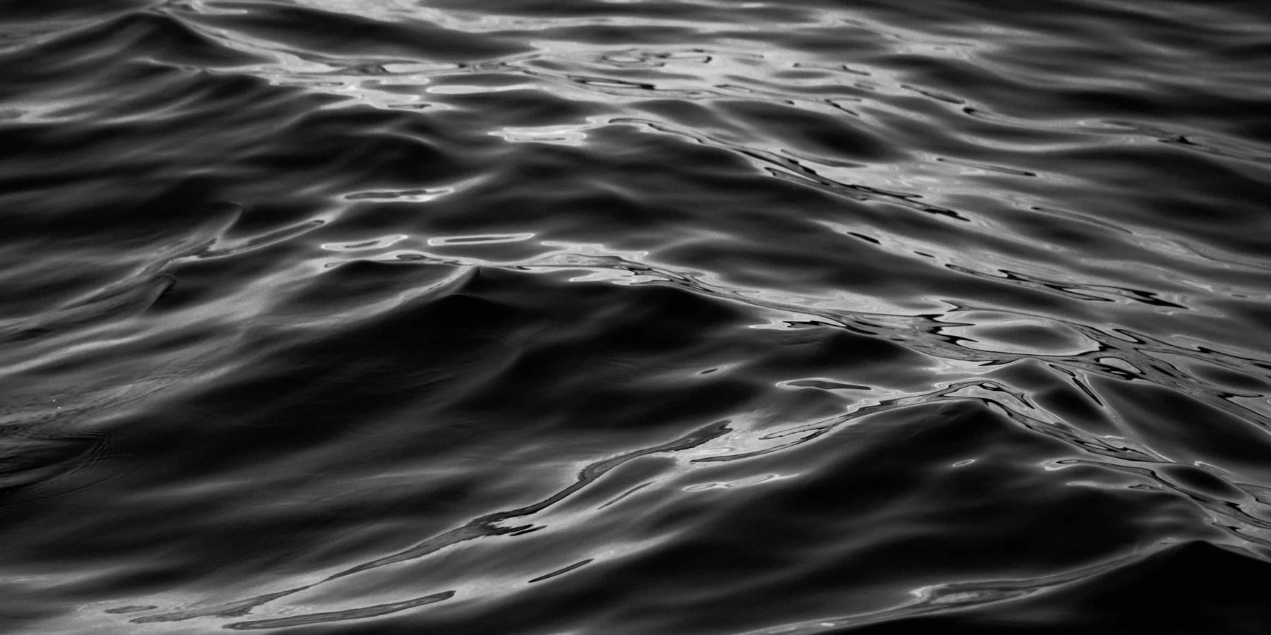 Black-and-white close-up of rippling water.